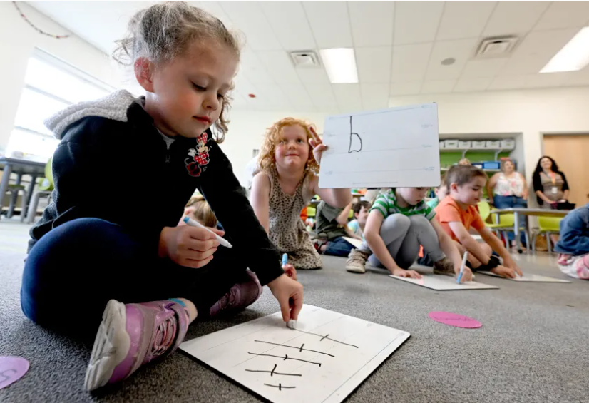 students drawing letters